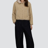 Front view of chantilly knitted jacket on model wearing black pants and sneakers, against a white background.