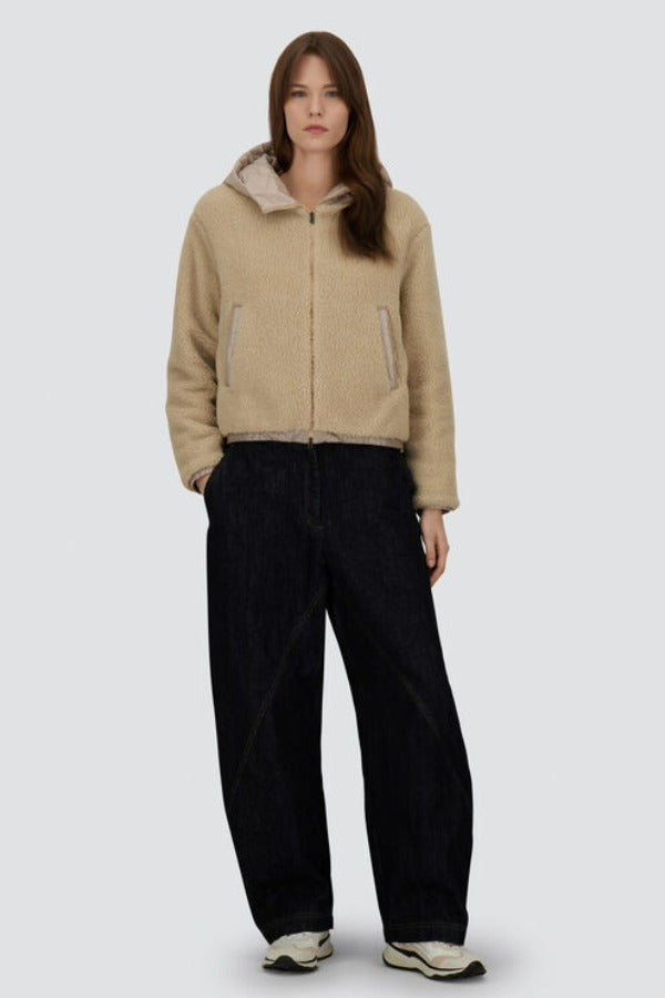 Front view of chantilly knitted jacket on model wearing black pants and sneakers, against a white background.
