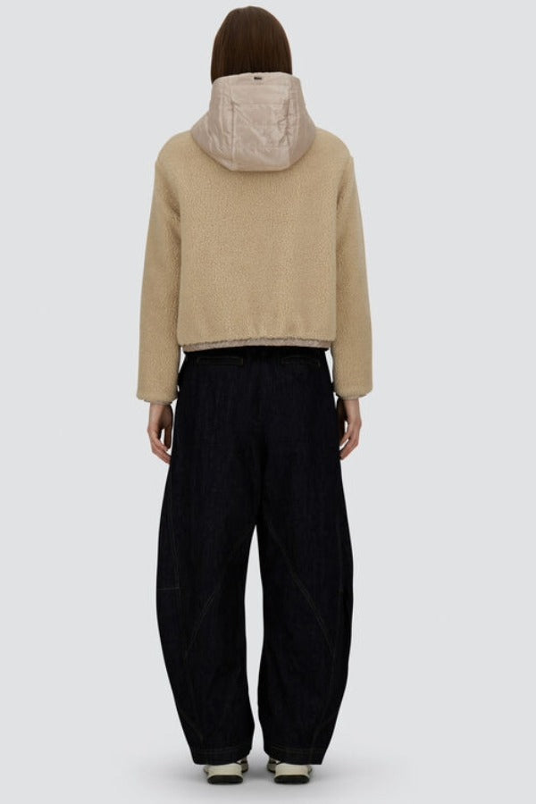 Back view of chantilly knitted jacket on model wearing black pants and sneakers, against a white background.