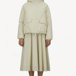 Alternate front view of panna scuro jacket on model wearing cream skirt and sneakers, against a white background.