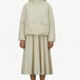 Alternate front view of panna scuro jacket on model wearing cream skirt and sneakers, against a white background.