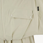 Front closeup view of panna scuro jacket on model wearing a cream skirt, against a white background.