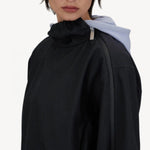Side view of black wool jacket on model, against a white background.