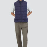 Front view of new blue gilet on model wearing green pants, white t-shirt and sneakers, against a white background.