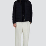 Front open view of blue men's jacket on model wearing white pants and black sneakers, against a white background.