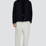 Front open view of blue men's jacket on model wearing white pants and black sneakers, against a white background.