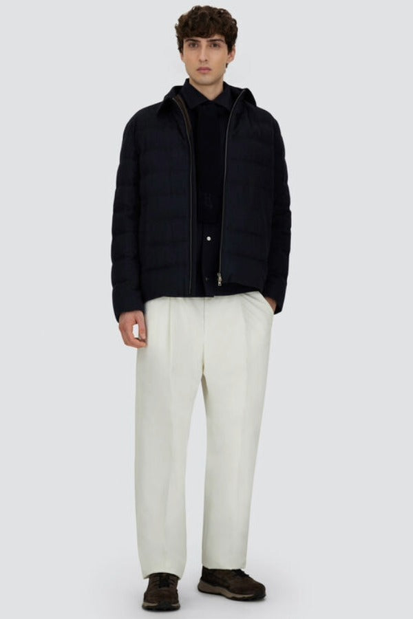 Front open view of blue men's jacket on model wearing white pants and black sneakers, against a white background.