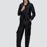 Front view of black bomber jacket on model wearing black t-shirt, trousers and mary janes against a white background.