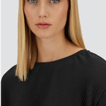 Front close up view of black pleated jersey t-shirt on model, against a white background.