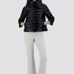 Front view of black sofia cape on model wearing white pants and sneakers, against a white background.