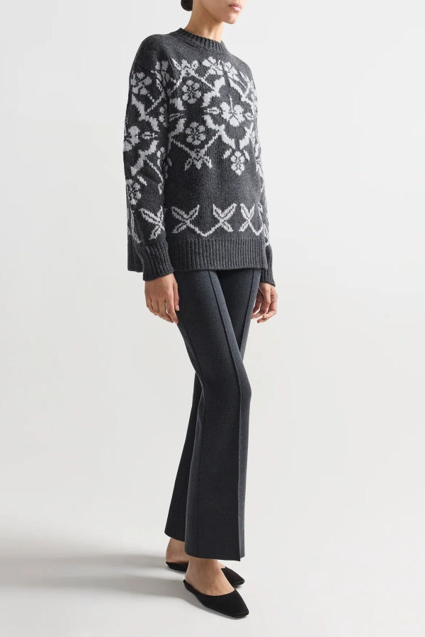 Alternate front view of charcoal geo kick pants on model wearing grey sweater and flats, against a white background.