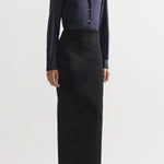 Front view of black lawton skirt on model wearing navy top and flats, against a white background.