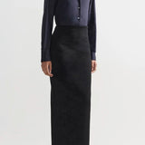 Front view of black lawton skirt on model wearing navy top and flats, against a white background.