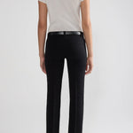 Back view of black tuxedo julep pants on model wearing white t-shirt and flats, against a white background.
