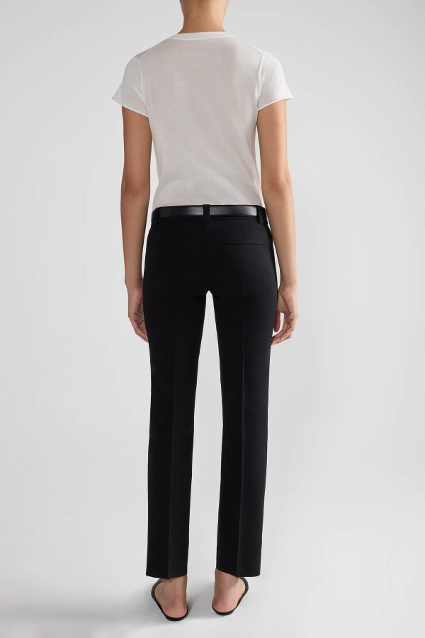 Back view of black tuxedo julep pants on model wearing white t-shirt and flats, against a white background.