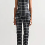 Front view of charcoal combo inna top on model wearing charcoal combo louis pants and flats, against a white background.