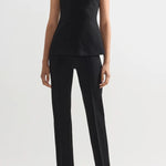 Front view of black combo windowpane inna top on model wearing black pants and flats, against a white background.