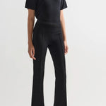 Front view of black combo windowpane louis pants on model wearing black t-shirt and flats, against a white background.