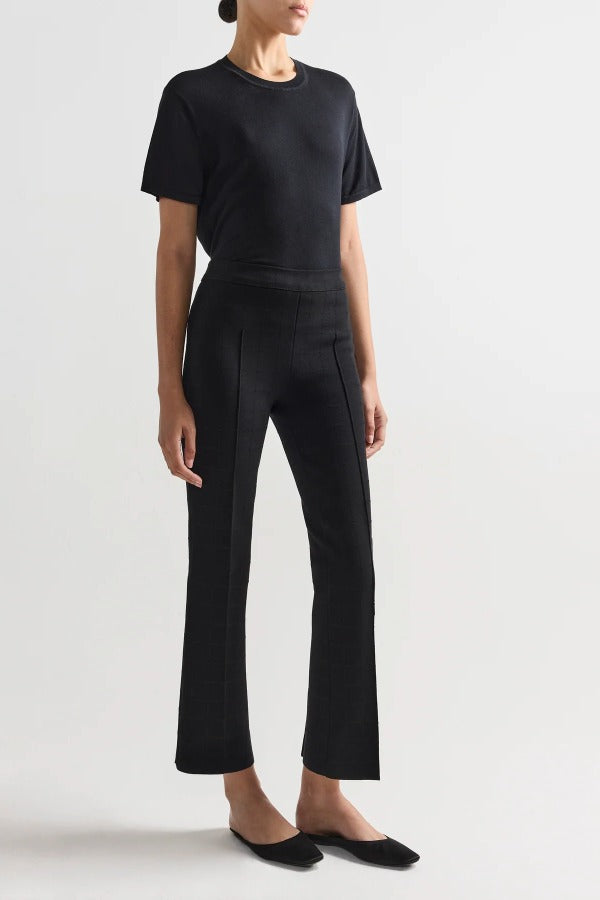 Front view of black combo windowpane louis pants on model wearing black t-shirt and flats, against a white background.