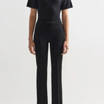 Alternate front view of black combo windowpane louis pants on model wearing black t-shirt and flats, against a white background.