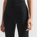 Front closeup of black combo windowpane louis pants on model wearing black t-shirt, against a white background.