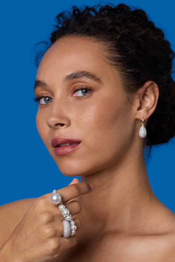 Front view of 18K WG YG Earrings on model, against a blue background.