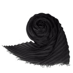 Front view of black coiled silk wool pleats stole on white background, with no model shown.