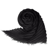 Front view of black coiled silk wool pleats stole on white background, with no model shown.