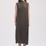 Front view of khaki soft fold pleats dress on model wearing black loafers, against a white background.