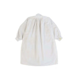 Back view of yellow PU Tunic on white background with no model shown.