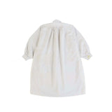 Back view of yellow PU Tunic on white background with no model shown.