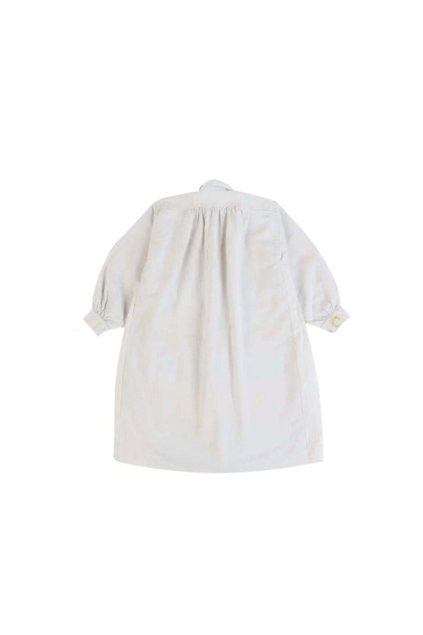 Back view of yellow PU Tunic on white background with no model shown.