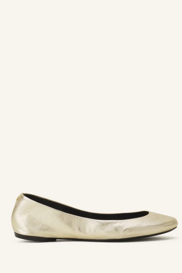 Left side view of gold ballerina flats on white background, with no model shown.