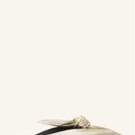 Right side view of gold flat mule bow on white background, with no model shown.