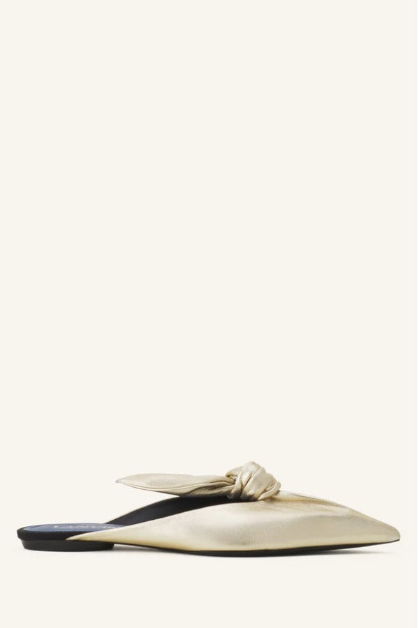 Right side view of gold flat mule bow on white background, with no model shown.