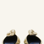 Back view of gold flat mule bow on white background, with no model shown.