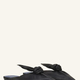 Pair view of black flat mule bow on white background, with no model shown.