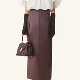 Front view of cloth puffy sleeves top on model wearing burgundy skirt and heels, against a white background.
