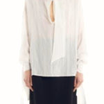 Front view of Ecru Scarf Blouse on model wearing black skirt, against a white background.