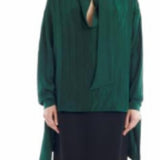Front view of malachite scarf blouse on model wearing black skirt, against a white backgorund.
