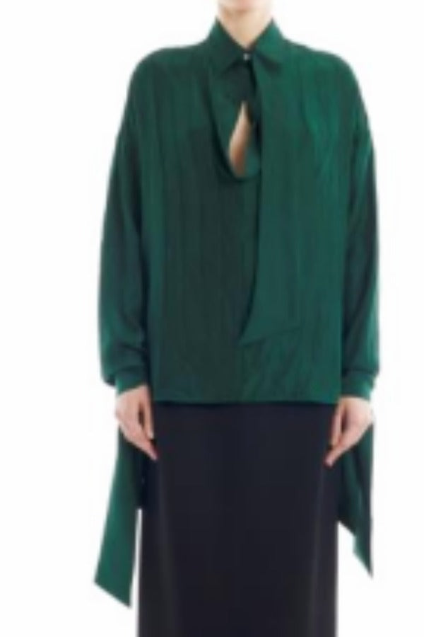 Front view of malachite scarf blouse on model wearing black skirt, against a white backgorund.