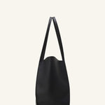 Alternate side view of black tote bag on white background, with no model shown.