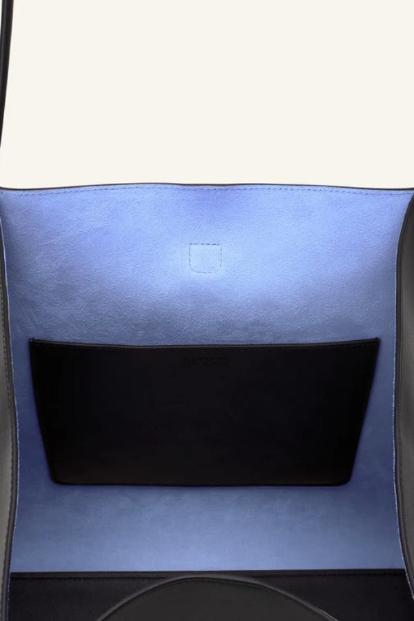 Open view of black tote bag on white background, with no model shown.
