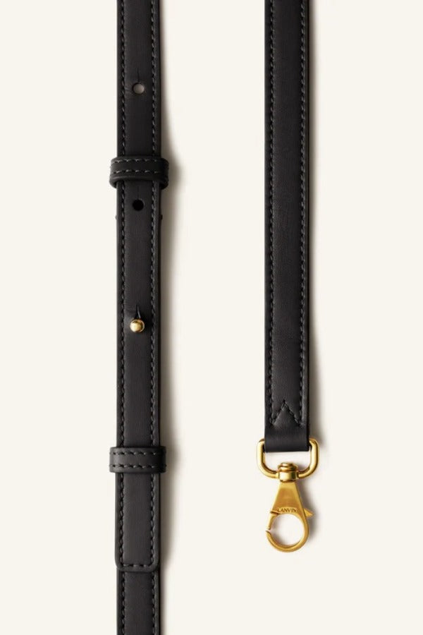 Strap view of black tote bag on white background, with no model shown.