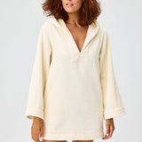 Front view of cream terry beach tunic on brown-haired model, against a white background.