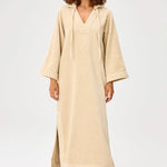 Front view of sand terry tunic caftan on model wearing brown sandals, against a white background.