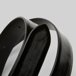Closeup of black marsell men's contorno belt on white background, with no model shown.