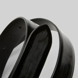 Closeup of black marsell men's contorno belt on white background, with no model shown.