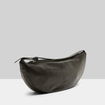 Side view of black marsell volta shoulder bag on white background, with no model shown.