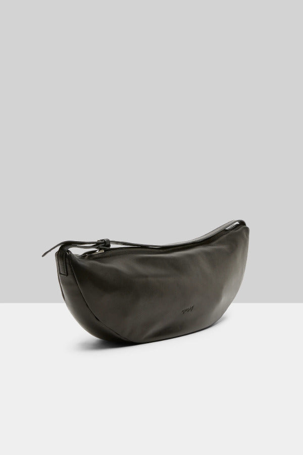 Side view of black marsell volta shoulder bag on white background, with no model shown.